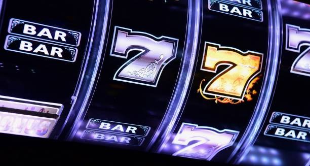 Mobile phone showing OVO and DANA payment method icons in login dan777 app